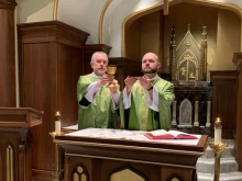 Father Eric Seitz says Mass, with his father, Deacon Ben Seitz, assisting as deacon. Courtesy photo.